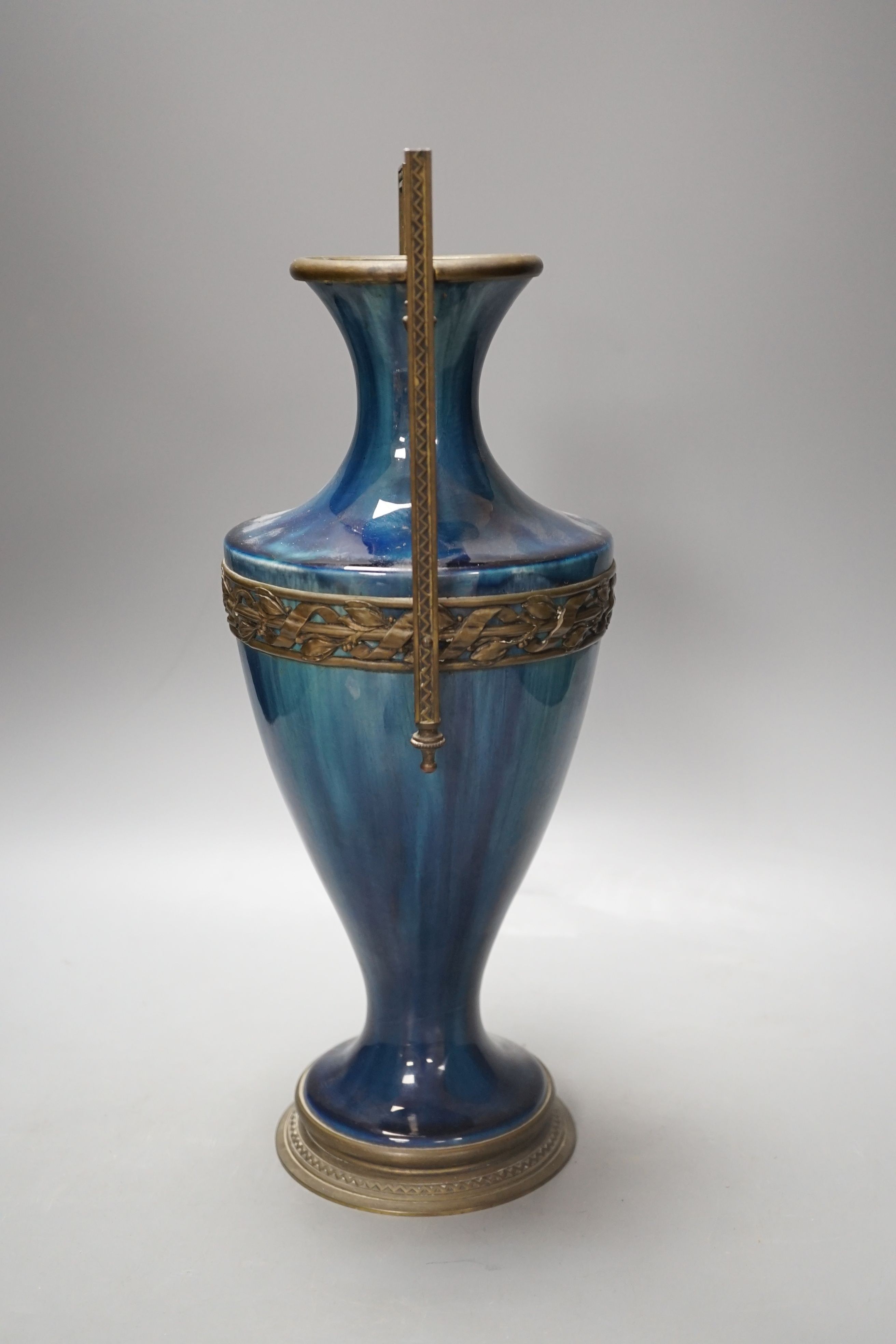 A French blue-glazed vase with embossed metal mounts, c.1900, 37 cms high.